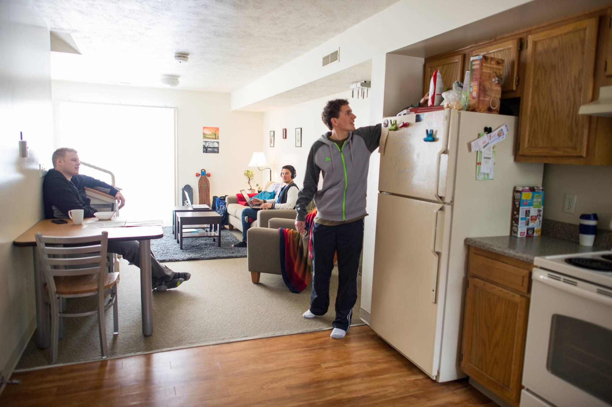 Image of students in a laker village apartment